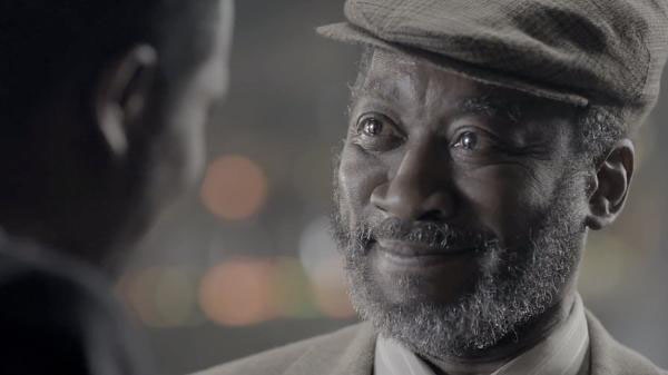 An old man smiling in Bell's 'The Reader' TV advert