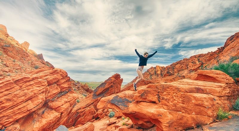 A woman jumping happily in the air (because video strategy is happening).